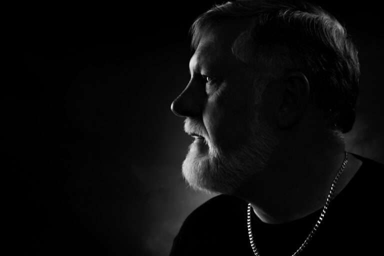 Christopher John portrait in side-lit studio profile