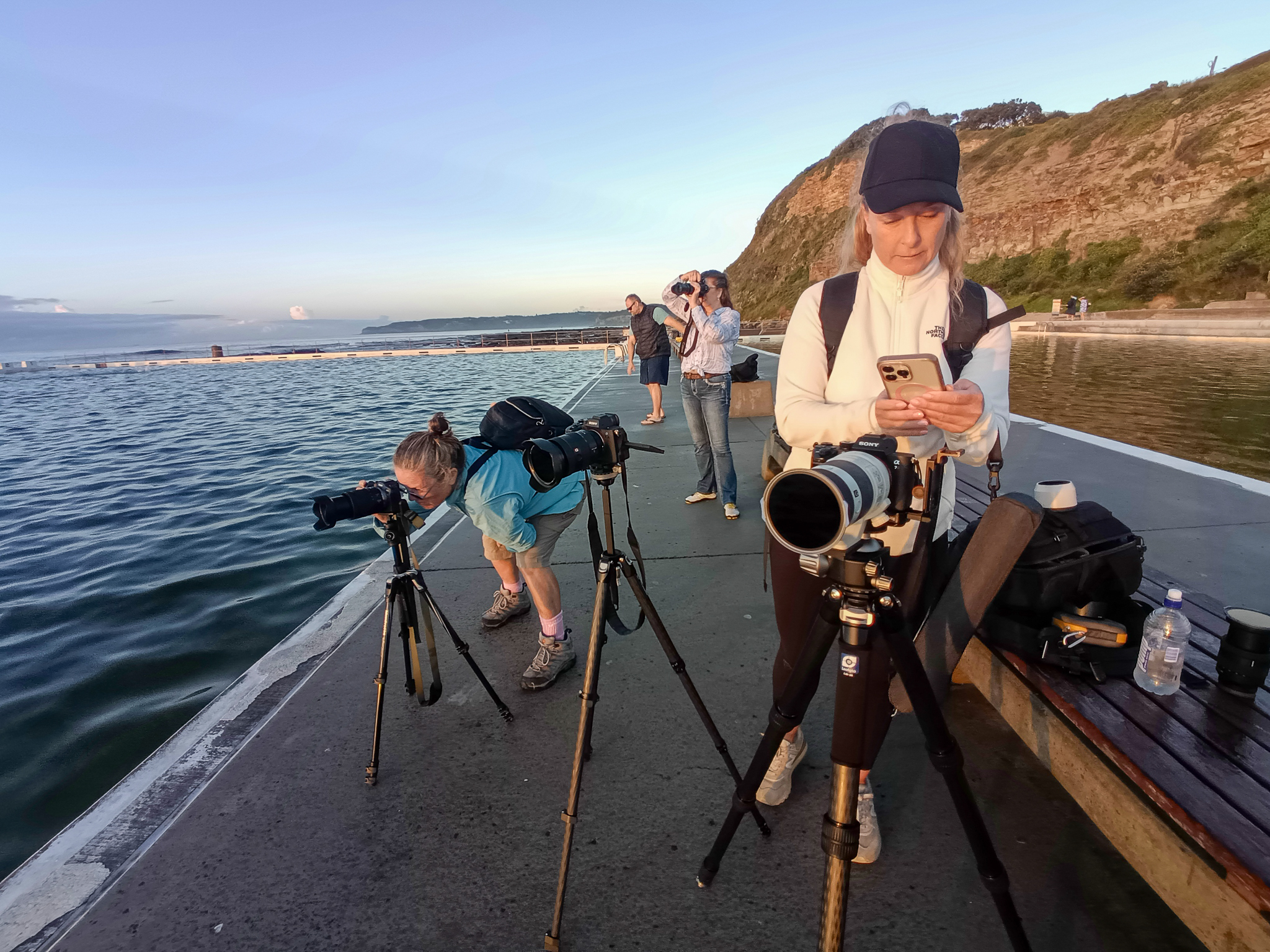Photography students photographing reflections at Merewether Ocean Baths workshop