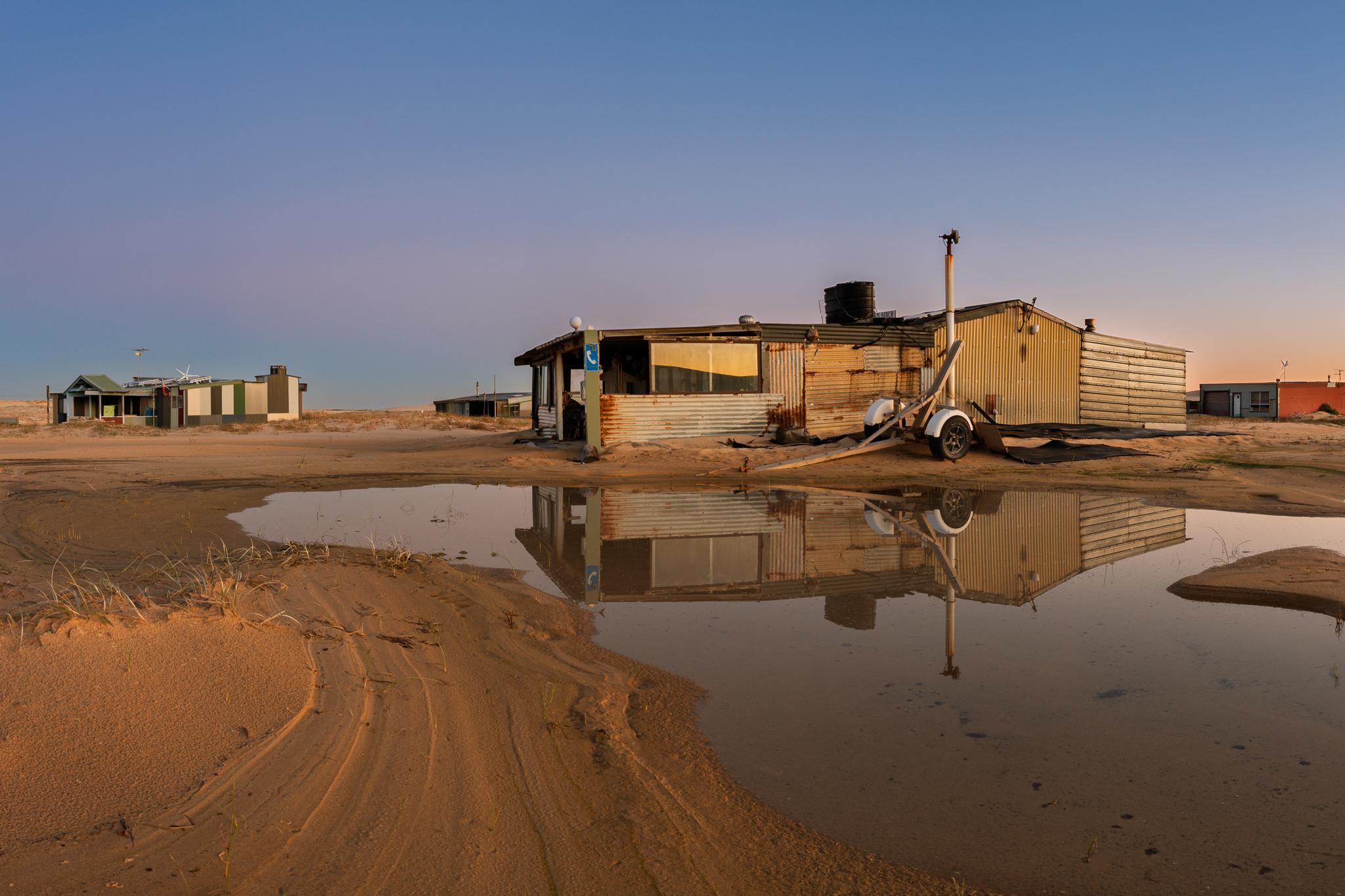 Tin City huts at Stockton Sand Dunes in Port Stephens photographed in late afternoon light during a coastal photography workshop