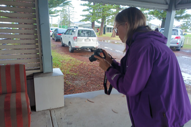 Beginner photographer practising camera skills during a hands-on photography workshop.