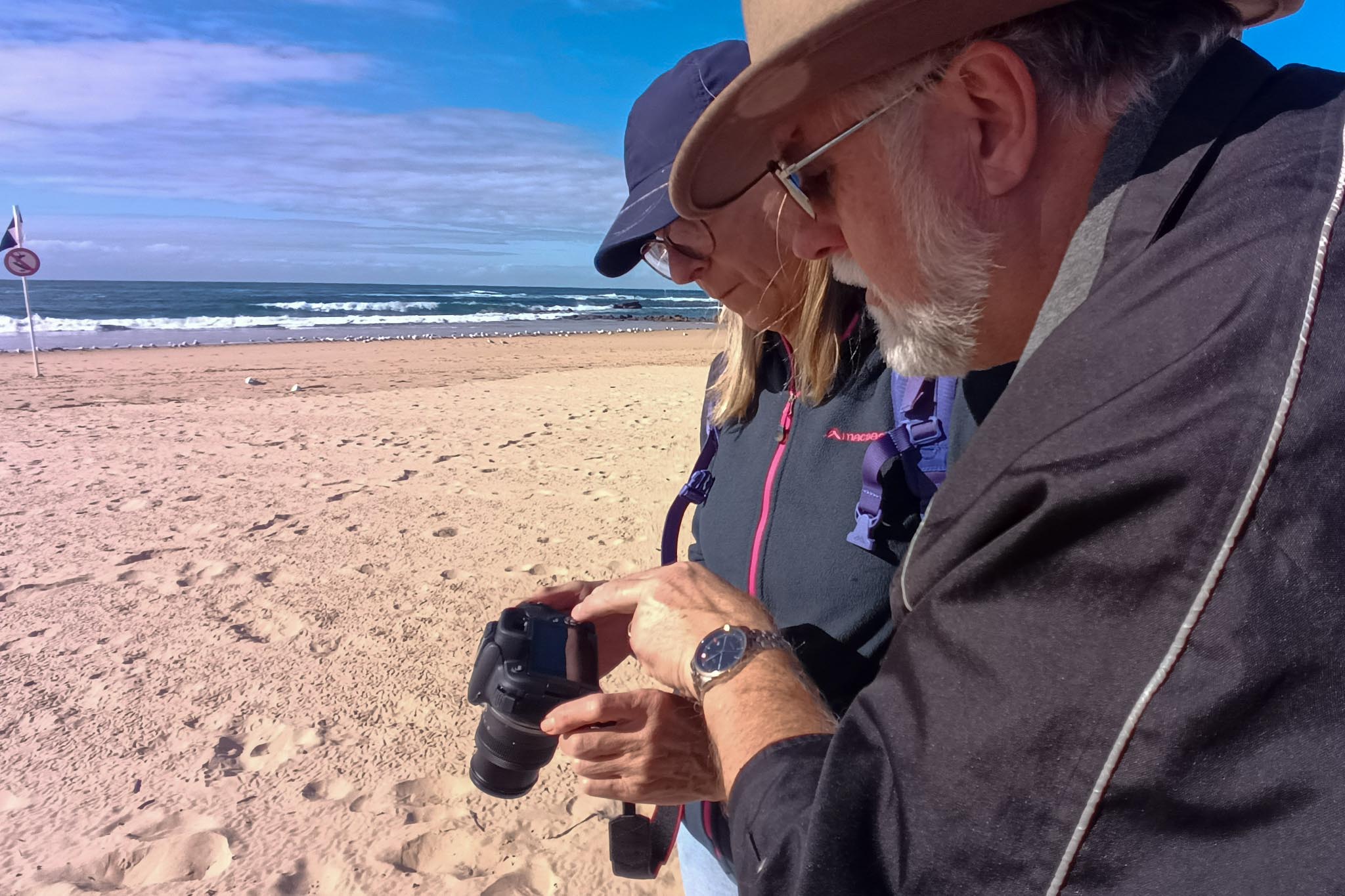 Beginner photographers receiving hands-on guidance during a Start Photography workshop for people with no photography experience.