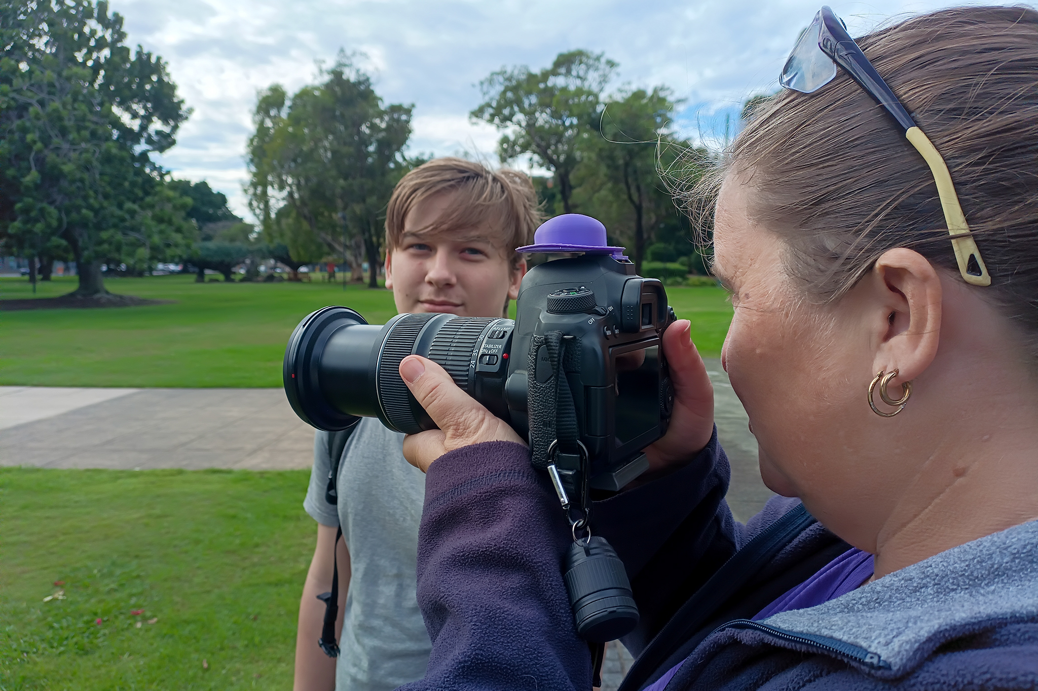 Beginner photography participant learning camera handling during a Crafted Image Academy workshop