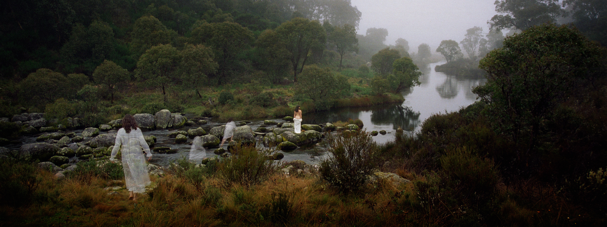 Fine art photograph showing multiple ghost-like figures moving through a misty river landscape - The Art of Intent