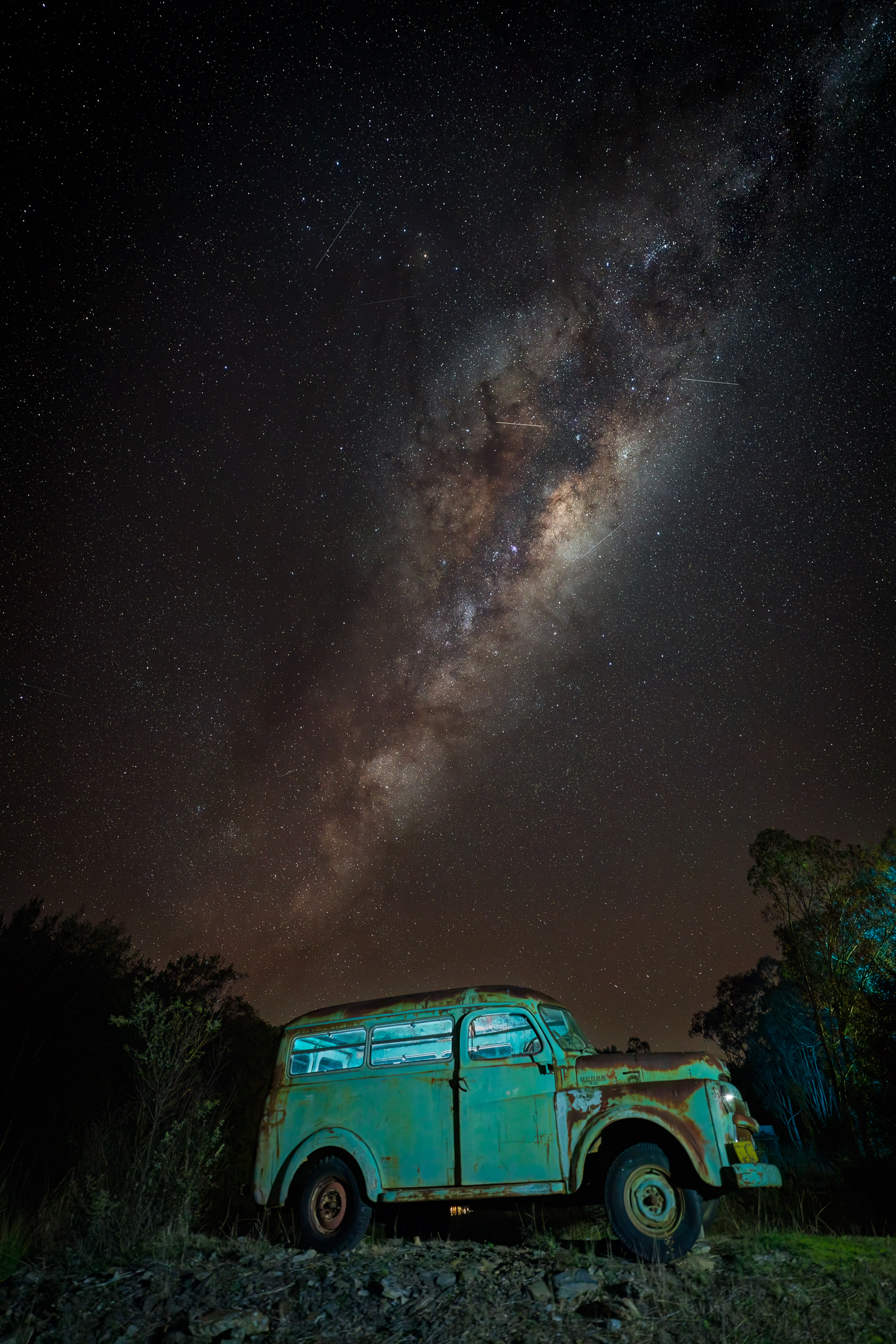 Milky Way arching above a vintage vehicle photographed at night using planned astrophotography techniques.