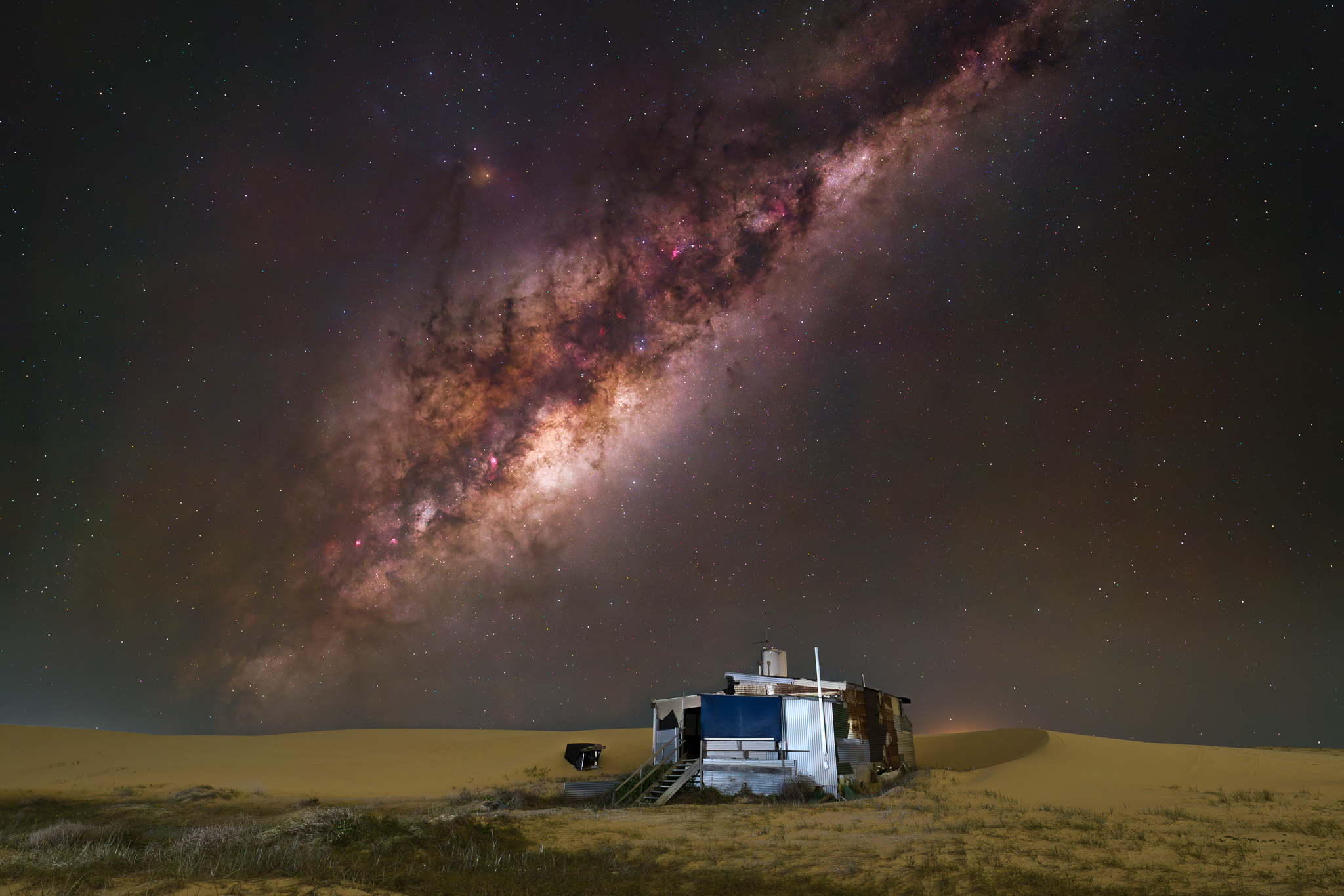 The Milky Way Core rising above the historic Tin City settlement in the Stockton Sand Dunes near Port Stephens.